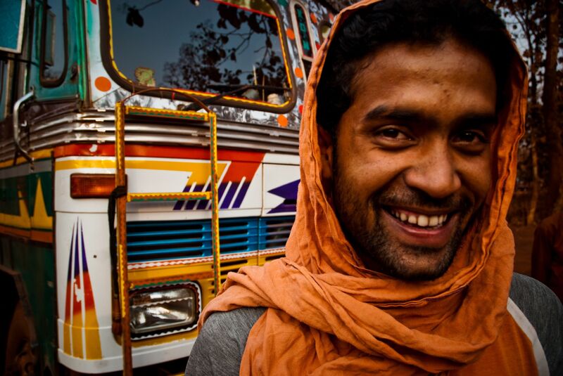 A long-distance truck driver in his cab on an Indian national highway.